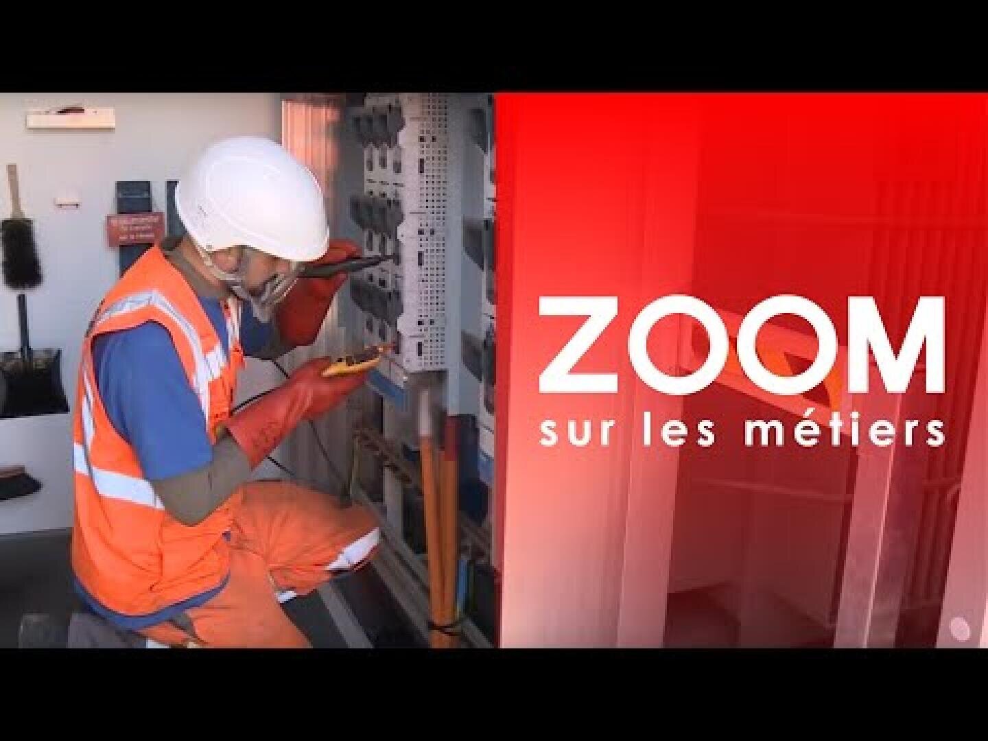 Un ouvrier de la construction portant un casque, un gilet de sécurité et des gants inspecte l'équipement électrique. Le texte ZOOM sur les métiers apparaît en rouge sur le côté droit de l'image.